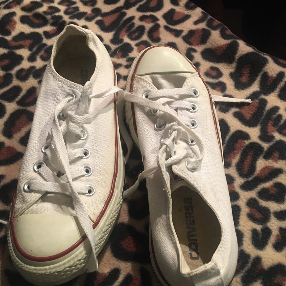 White Converse low top tennis shoes.